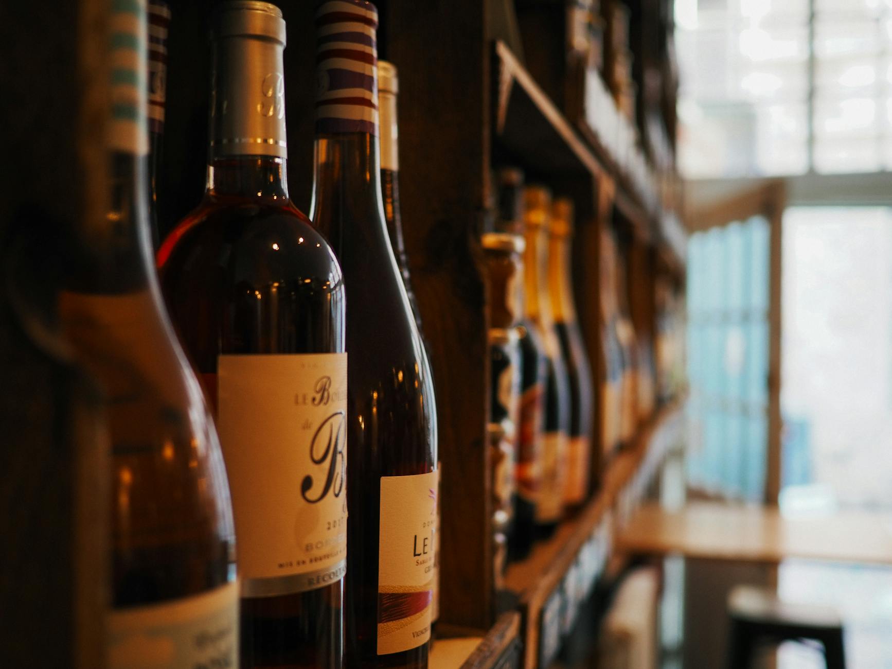 photo of wine bottles on rack